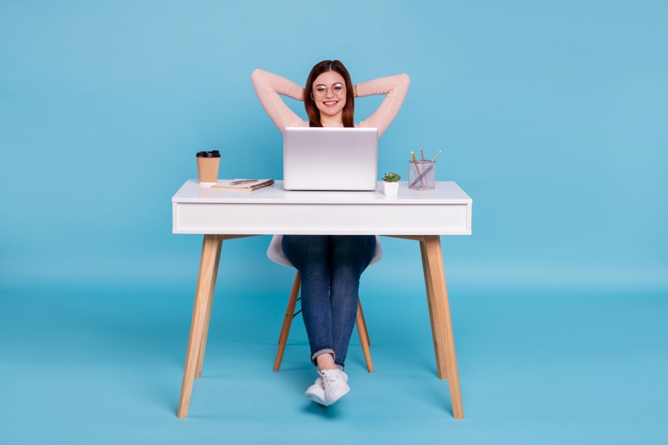 Women business owner celebrating AI overview success with victory gesture at desk