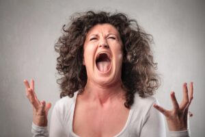 Frustrated female entrepreneur discovering hosting provider blocking AI bots