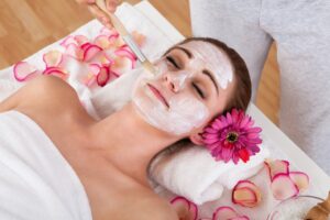 Woman receiving professional facial treatment at local spa - representing local service businesses that benefit from voice search and AI assistant optimisation