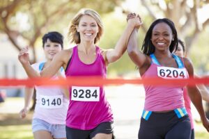 Business woman breaking through finish line tape, symbolising 4x higher conversion rates from AI search traffic