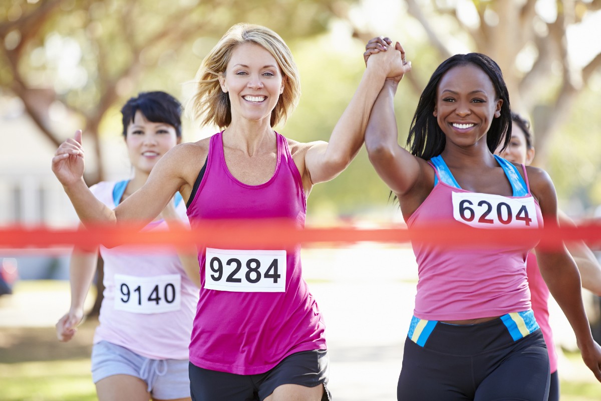 Business woman breaking through finish line tape, symbolising 4x higher conversion rates from AI search traffic